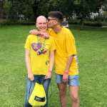 Pride picture of me, wearing an Amesty t-shirt, and being kissed on the head by a stranger